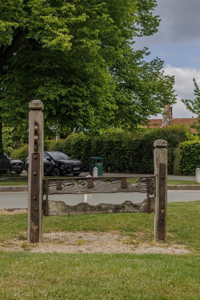 The old stocks and whipping post preserved in the Aldbury village centre.